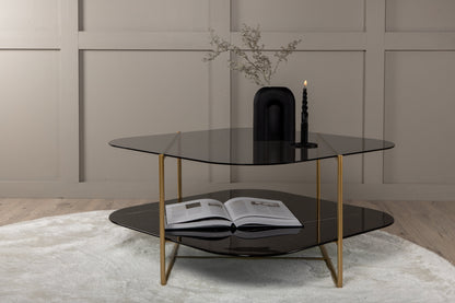 un-line Sofatisch aus Glas und Stahl in Schwarz/Gold